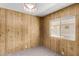 Bedroom showcasing wood paneling and window with natural light at 303 S Recker Rd # 141, Mesa, AZ 85206