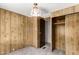 Bedroom featuring wood paneling, carpet, closet, and door at 303 S Recker Rd # 141, Mesa, AZ 85206