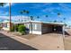 Charming single-story home with covered parking, desert landscaping, and palm trees at 303 S Recker Rd # 141, Mesa, AZ 85206