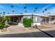 Charming single-story home with covered parking, desert landscaping, and palm trees at 303 S Recker Rd # 141, Mesa, AZ 85206