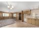 Living room and kitchen area with neutral tones, ceiling fan, and ample natural light at 303 S Recker Rd # 141, Mesa, AZ 85206