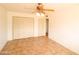 Bedroom features tile floors, standard closet doors, and ceiling fan at 36655 N 25Th St, Cave Creek, AZ 85331