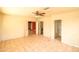 Bedroom with tile flooring, a ceiling fan, and access to two other rooms and a closet at 36655 N 25Th St, Cave Creek, AZ 85331