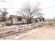 Ranch-style home with solar panels and a rustic white fence in a desert landscape at 36655 N 25Th St, Cave Creek, AZ 85331