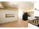 Traditional kitchen with white cabinetry, tiled floor, and black appliances at 36655 N 25Th St, Cave Creek, AZ 85331