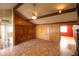 Living room with vaulted ceiling, wood beam accents, wood paneling, and tile flooring at 36655 N 25Th St, Cave Creek, AZ 85331