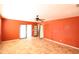 Living room featuring tile flooring, ceiling fan, red walls, and sliding glass doors to the exterior at 36655 N 25Th St, Cave Creek, AZ 85331