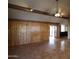Living room with tile floors, wood-beam accents, and wood paneling at 36655 N 25Th St, Cave Creek, AZ 85331