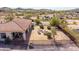 Aerial view of backyard featuring a fire pit with seating, covered patio and desert landscaping at 3723 S Pottery Rd, Gold Canyon, AZ 85118
