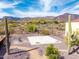Backyard concrete basketball court surrounded by desert landscape with scenic mountain views at 3723 S Pottery Rd, Gold Canyon, AZ 85118