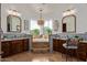 Luxurious bathroom featuring a soaking tub, dual vanities, and tile flooring at 3723 S Pottery Rd, Gold Canyon, AZ 85118