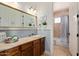 Charming bathroom with light blue tiling, a large mirror, and a combined bathtub and shower at 3723 S Pottery Rd, Gold Canyon, AZ 85118