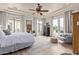 Large, well-lit bedroom with white bedding, wood floors, and a view of the outdoor pool at 3723 S Pottery Rd, Gold Canyon, AZ 85118