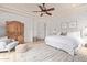 Bright bedroom with a decorative ceiling fan, wooden accent cabinet, and decorative rug at 3723 S Pottery Rd, Gold Canyon, AZ 85118