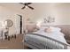Serene bedroom featuring a queen bed, a vanity area, and a walk-in closet for optimal storage at 3723 S Pottery Rd, Gold Canyon, AZ 85118