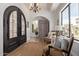 Grand entryway featuring arched doorway, chandelier, tile flooring, and neutral-toned seating at 3723 S Pottery Rd, Gold Canyon, AZ 85118