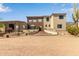 Stunning desert home featuring unique stone accents, multiple levels, and beautiful landscaping under a bright blue sky at 3723 S Pottery Rd, Gold Canyon, AZ 85118