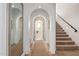 Beautiful hallway featuring arched doorways and staircase with neutral carpet at 3723 S Pottery Rd, Gold Canyon, AZ 85118