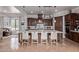 Spacious kitchen featuring a large island with seating, dark wood cabinetry, and modern appliances at 3723 S Pottery Rd, Gold Canyon, AZ 85118