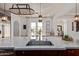 Bright kitchen boasts a spacious island with stainless steel sink and ample counter space, perfect for cooking and entertaining at 3723 S Pottery Rd, Gold Canyon, AZ 85118