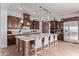 Gourmet kitchen with dark wood cabinets, a large island with seating, and stainless steel appliances at 3723 S Pottery Rd, Gold Canyon, AZ 85118