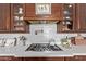 Kitchen featuring white backsplash, stainless steel gas range, and custom wood cabinets at 3723 S Pottery Rd, Gold Canyon, AZ 85118