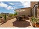 Lovely outdoor patio area with a dining set and partial shade, perfect for enjoying the desert views at 3723 S Pottery Rd, Gold Canyon, AZ 85118