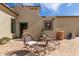 A cozy outdoor patio with comfortable seating, lush plants, and artistic wall decor at 3723 S Pottery Rd, Gold Canyon, AZ 85118