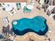 Aerial view of backyard pool with lounge area, outdoor dining, and lush landscaping at 3723 S Pottery Rd, Gold Canyon, AZ 85118