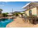 Inviting backyard pool area featuring a bar, seating, and serene mountain views for outdoor entertainment at 3723 S Pottery Rd, Gold Canyon, AZ 85118