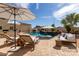 Backyard pool area with lounge chairs, umbrellas, and blue skies perfect for entertaining and relaxation at 3723 S Pottery Rd, Gold Canyon, AZ 85118