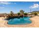 Sparkling pool with brick trim, lush landscaping, and desert scenery at 3723 S Pottery Rd, Gold Canyon, AZ 85118