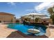 Inviting pool with unique in-water table, palm trees, and a tranquil ambiance at 3723 S Pottery Rd, Gold Canyon, AZ 85118
