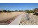 Community disc golf course featuring walking path, trees, bushes, and rock lined areas at 4179 W Brenley Dr, San Tan Valley, AZ 85144