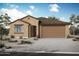 Charming single-story home with a two-car garage and desert landscaping enhancing curb appeal at 4179 W Brenley Dr, San Tan Valley, AZ 85144