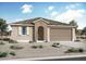 Inviting single-story home with a tiled roof, neutral stucco, paired with a two-car garage and desert landscaping at 4216 W Brenley Dr, San Tan Valley, AZ 85144