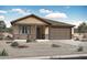 Charming single-story home featuring stone accents, neutral colors, and a two-car garage at 4226 W Brenley Dr, San Tan Valley, AZ 85144