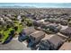 Aerial showing homes in a suburban neighborhood, with green spaces and mountain views at 4626 N 111Th Ln, Phoenix, AZ 85037