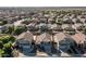 An aerial perspective of a well-planned neighborhood with neatly arranged homes and desert landscape at 4626 N 111Th Ln, Phoenix, AZ 85037