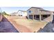 View of the home's spacious backyard with a covered patio, and a concrete block fence surrounding the property at 4626 N 111Th Ln, Phoenix, AZ 85037
