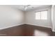 Clean bedroom features hardwood floors, natural light and a contemporary ceiling fan at 4626 N 111Th Ln, Phoenix, AZ 85037