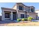 Beautiful two-story home with decorative pillars, tiled roof, and lush front yard landscaping at 4626 N 111Th Ln, Phoenix, AZ 85037