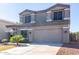 Home exterior featuring a neutral color scheme, manicured lawn, and well-maintained driveway at 4626 N 111Th Ln, Phoenix, AZ 85037