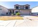 Two story home with desert landscaping, concrete driveway, and neutral exterior paint at 4626 N 111Th Ln, Phoenix, AZ 85037