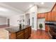 Spacious open kitchen featuring wood cabinetry, a central island, and modern appliances at 4626 N 111Th Ln, Phoenix, AZ 85037