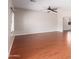 Large open living room with modern fan, wood-look floors and neutral colors at 4626 N 111Th Ln, Phoenix, AZ 85037