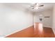 Open-concept living room with beautiful hardwood floors, ceiling fan and natural light at 4626 N 111Th Ln, Phoenix, AZ 85037
