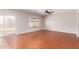 Bright living room showcasing wood-look floors, large sliding glass door, and neutral paint at 4626 N 111Th Ln, Phoenix, AZ 85037
