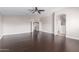 Spacious living room boasts wood floors, neutral paint, and an open layout with a doorway and an arched pass-through at 4626 N 111Th Ln, Phoenix, AZ 85037
