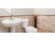 Stylish half-bathroom with tile accents, a modern vessel sink, and a decorative vase at 4626 N 111Th Ln, Phoenix, AZ 85037